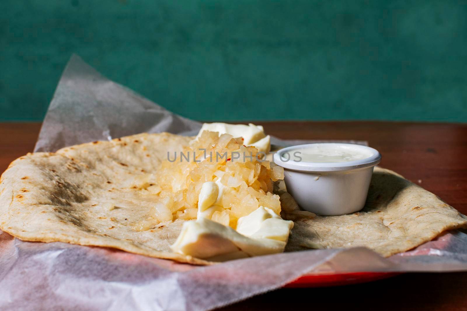 Close up of Nicaraguan Quesillo served on wooden table. Traditional Nicaraguan Quesillo served on wooden table, Traditional Nicaraguan Quesillo served on wooden table with copy space