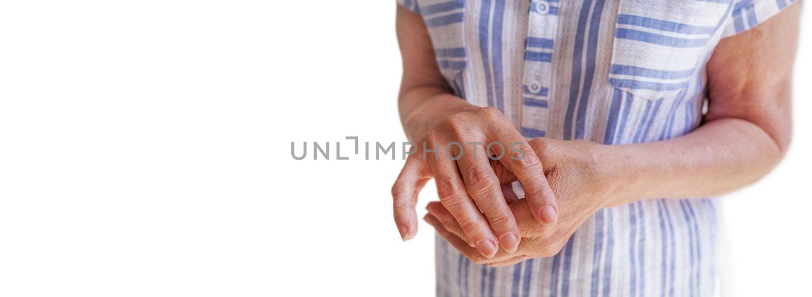 long banner on a white background. Close-up of an old woman's hand with arthritis. The concept of age-related changes, diseases of the joints and bones. Woman giving herself a hand and arm massage