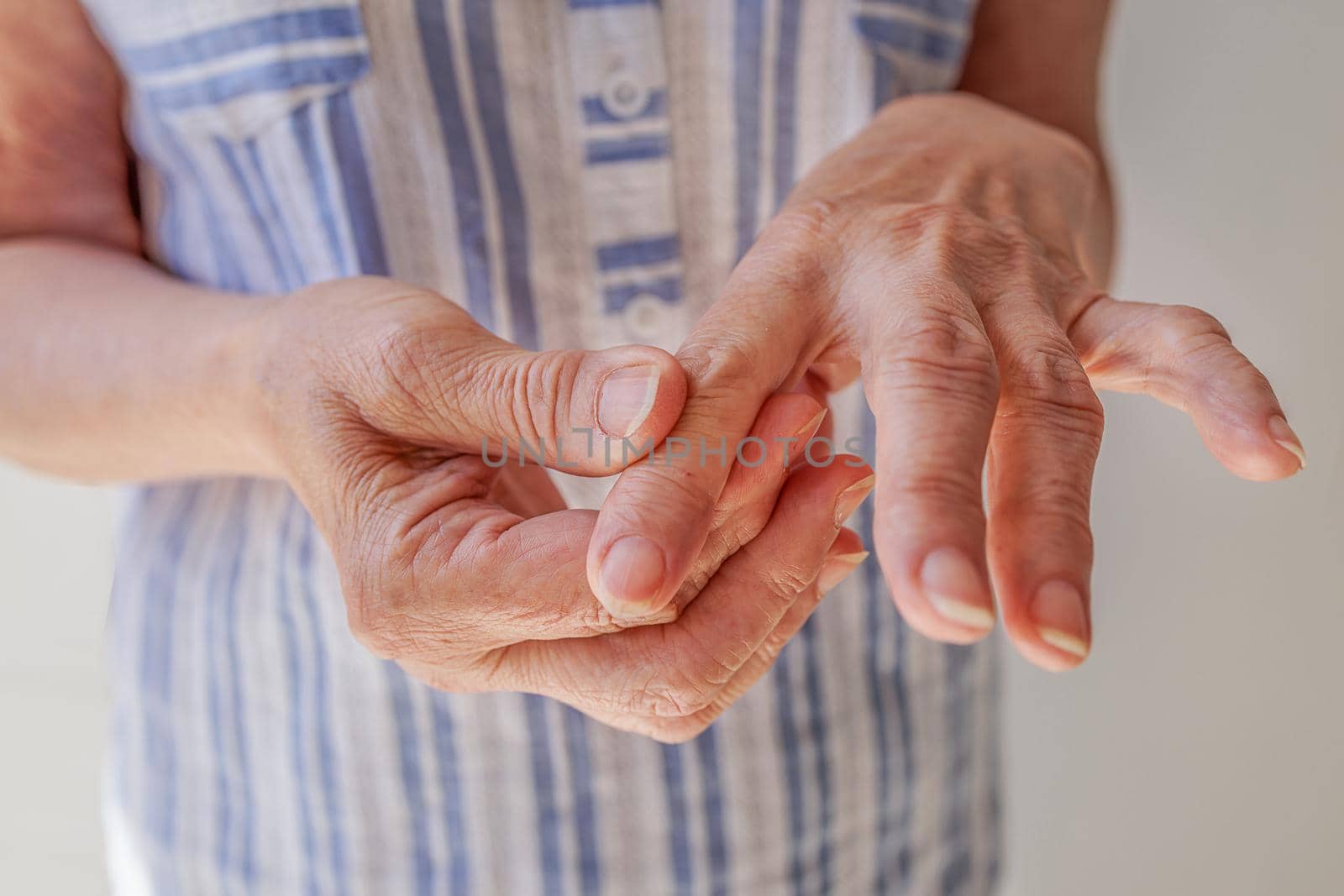close-up, an old woman makes herself a hand massage, arthritis, arthrosis by Ramanouskaya