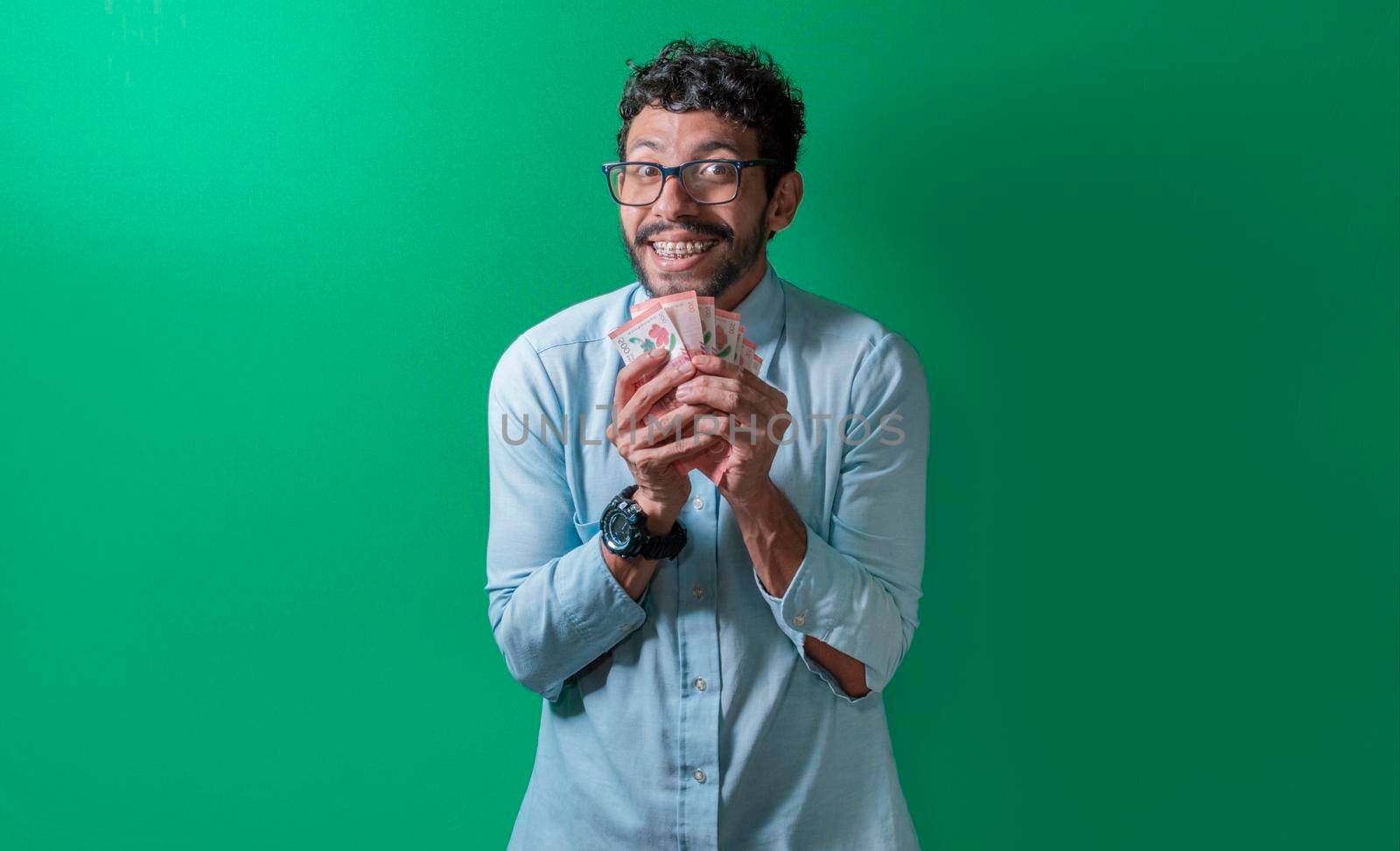Friendly and happy man with money in his hands looking at the camera, Happy person with money in his hands isolated. Happy person with money in his hands looking at the camera