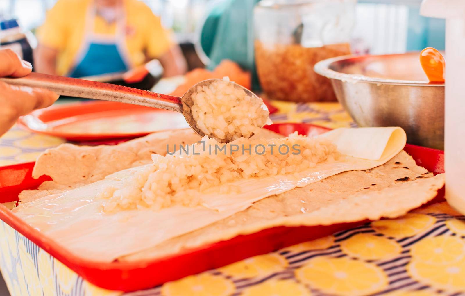 View of the traditional Quesillo with pickled onion, Preparation of the Traditional Nicaraguan Quesillo. Hands making delicious Nicaraguan Quesillo. Central American food the Quesillo