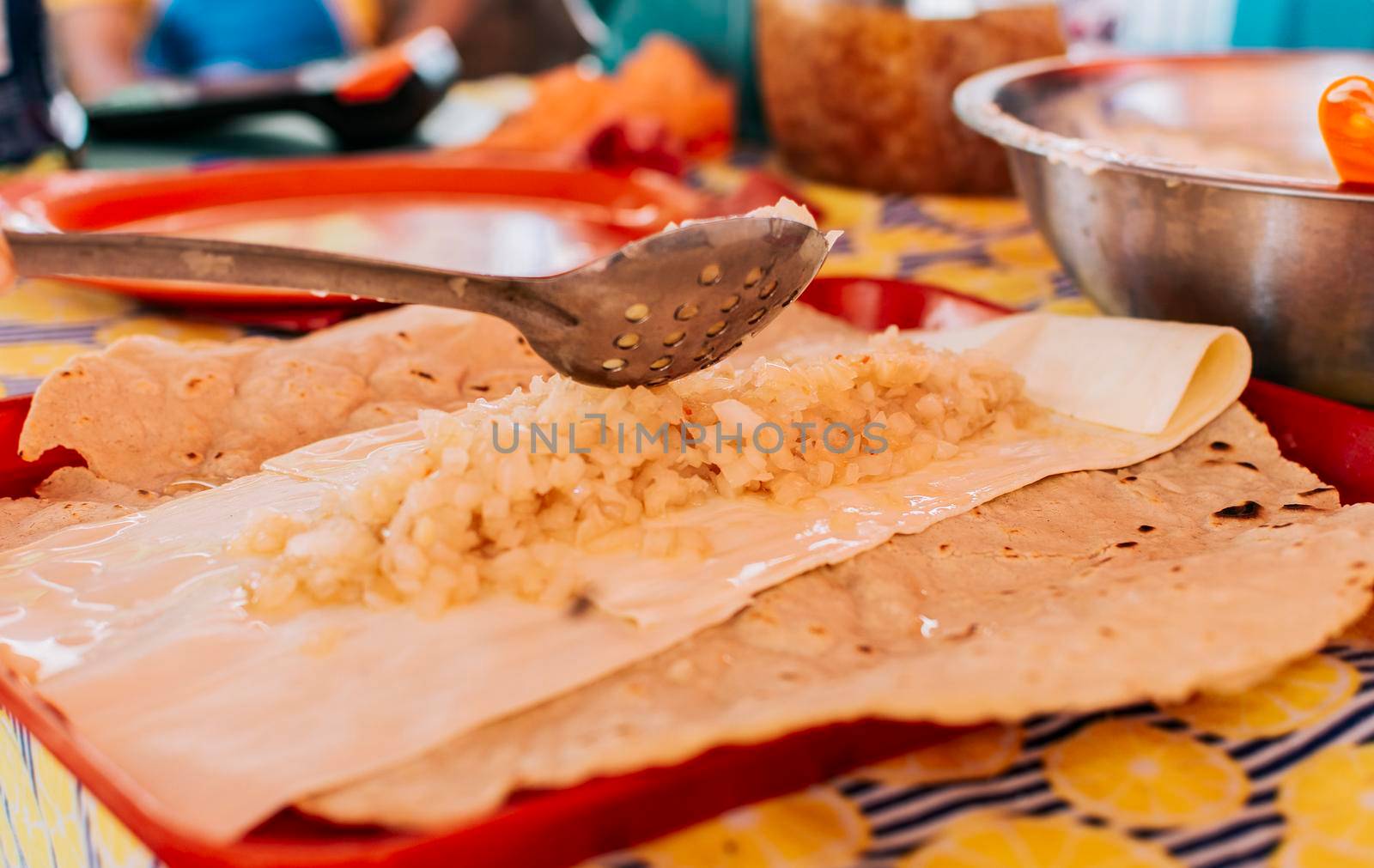 Preparation of the Traditional Nicaraguan Quesillo. Hands making delicious Nicaraguan Quesillo. Central American food the Quesillo, View of the traditional Quesillo with pickled onion