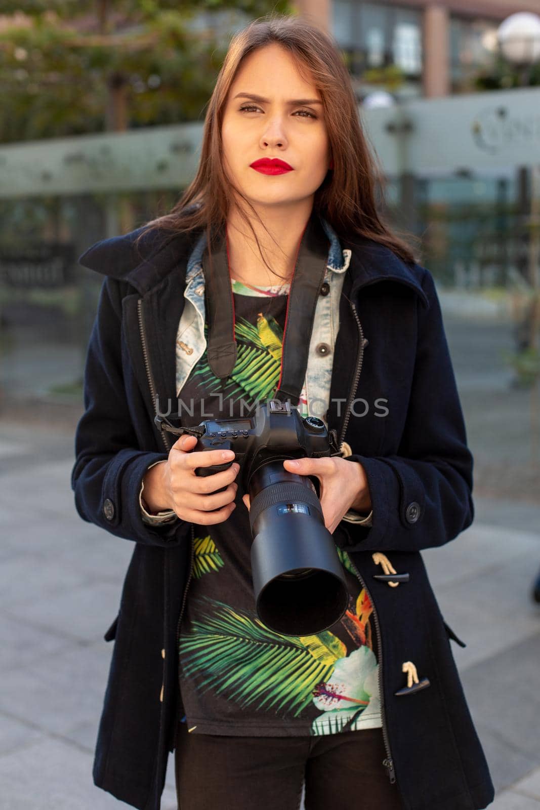 Attractive tourist woman photographer with camera, outdoor in city street. Gorgeous happy caucasian female in casual hipster clothes