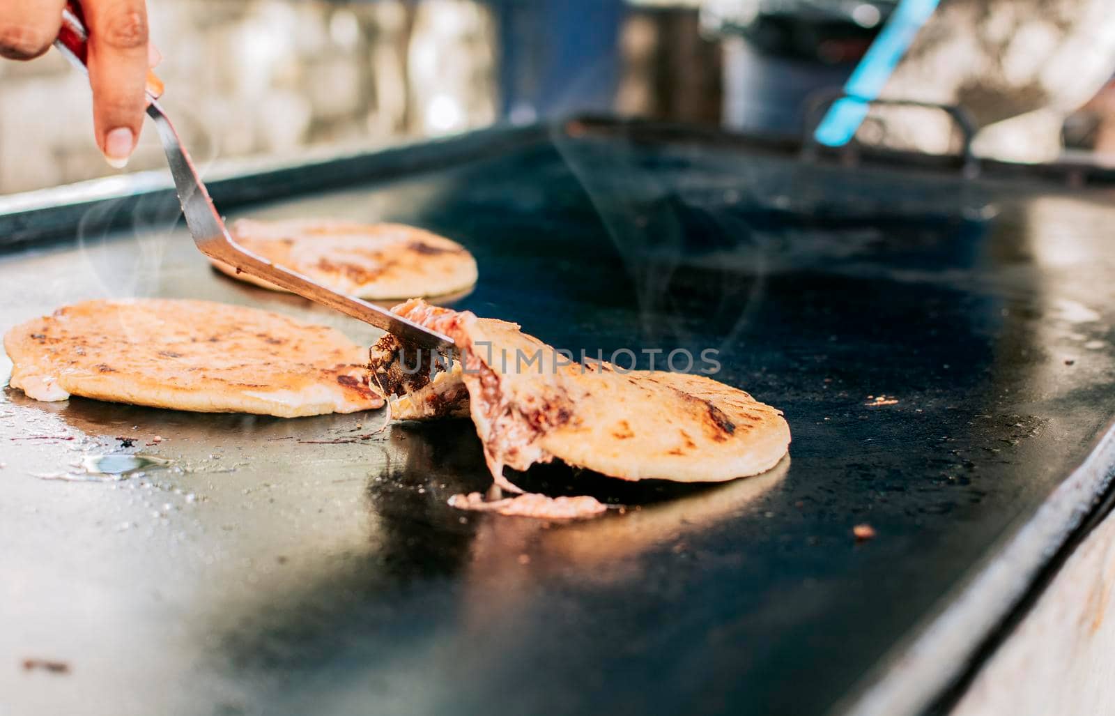 Traditional grilled cheese pupusas, Close up of traditional handmade pupusas on grill. Traditional Nicaraguan Pupusas with melted cheese on grill