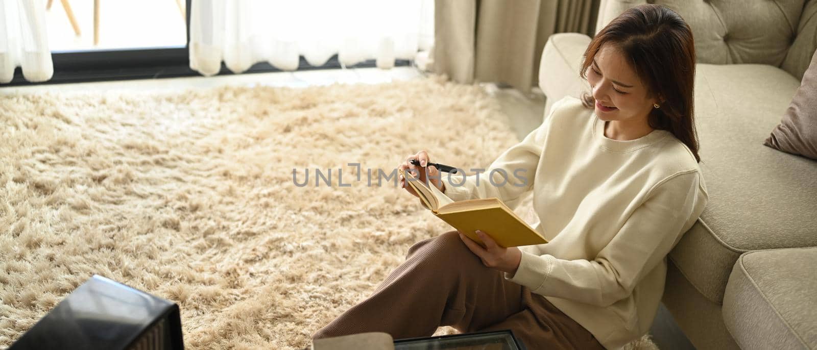 Pleasant woman making notes, agenda plan planning daily appointment on notebook. Leisure activity, positive mood concept.