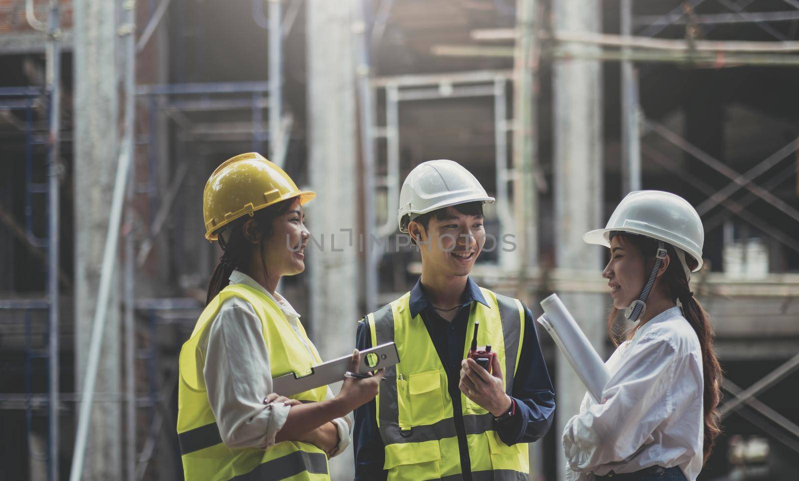 Professional Construction and Engineer team Working on workplace. Professional black architect and construction worker working look at blueprint plan on site..