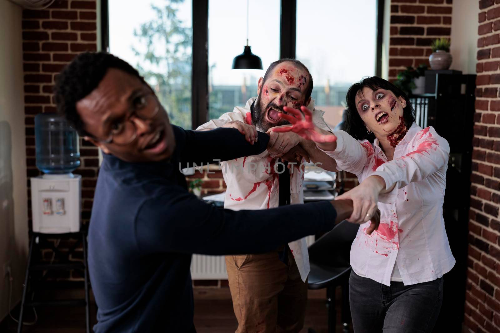 Cruel spooky zombies chasing after businessman, frightened person running from brain eating bloodthirsty monsters. Scared man being afraid of undead aggressive corpses, walking dead.