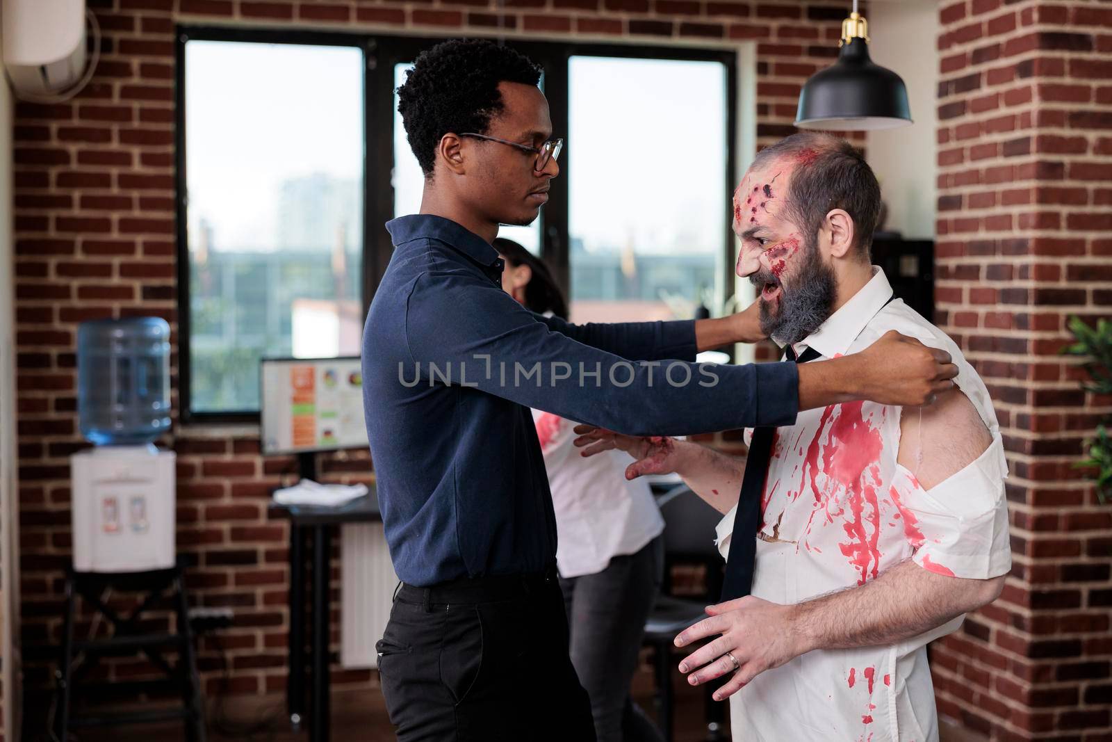 Creepy eerie zombie talking to man at workplace by DCStudio