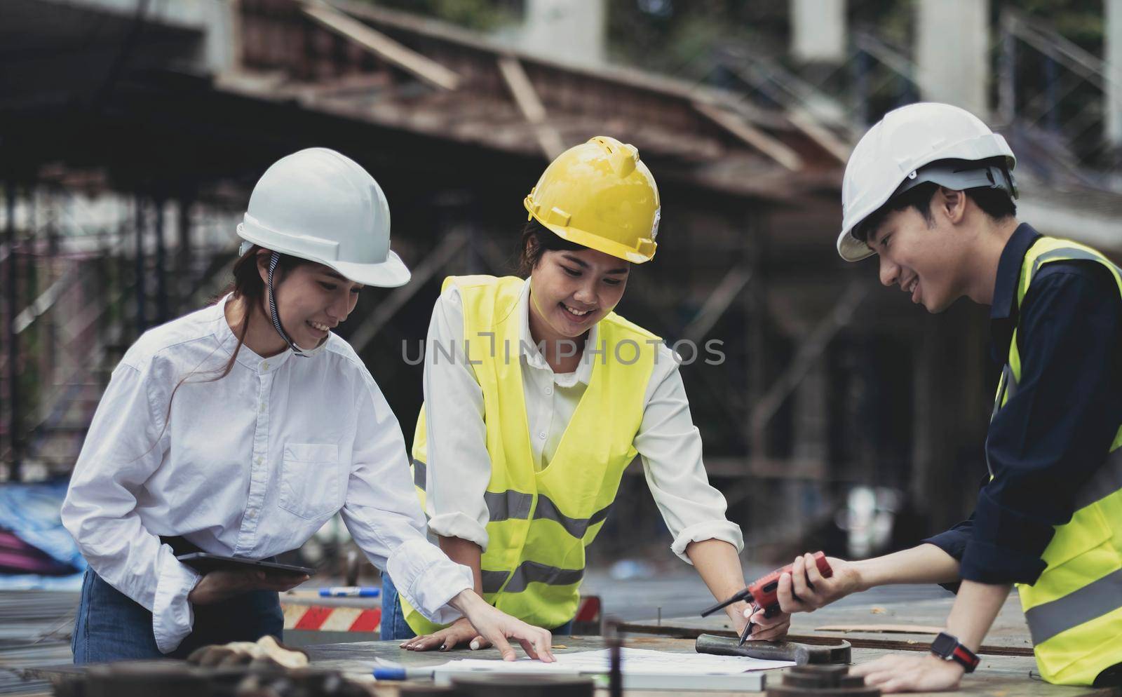 Three experts inspect commercial building construction sites, industrial buildings real estate projects with civil engineers, investors use laptops in background home, concrete formwork framing..