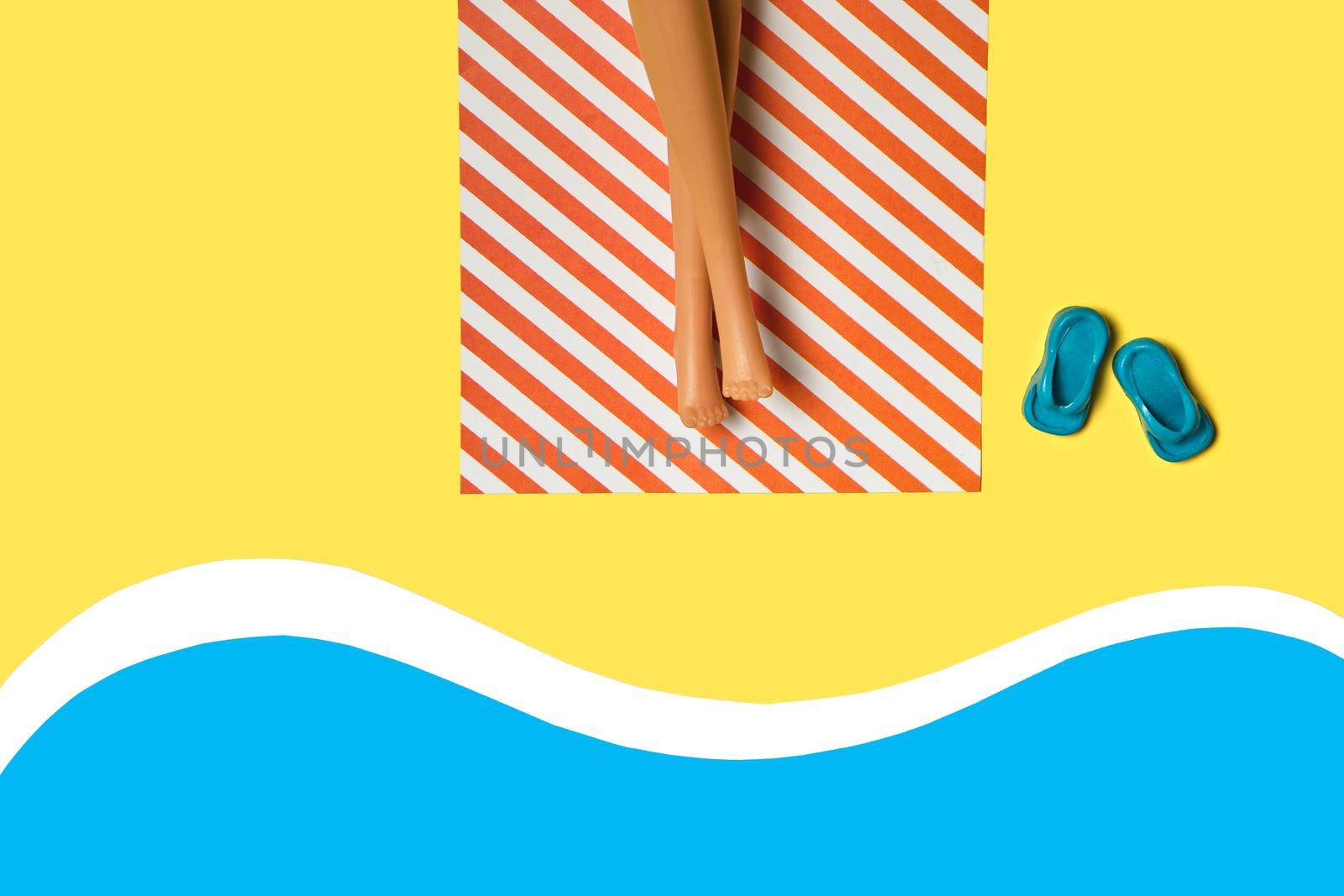 Creative minimal beach concept. Summer vacation layout with doll legs on beach towels, flat pool, beach, yellow background. Flat lay.