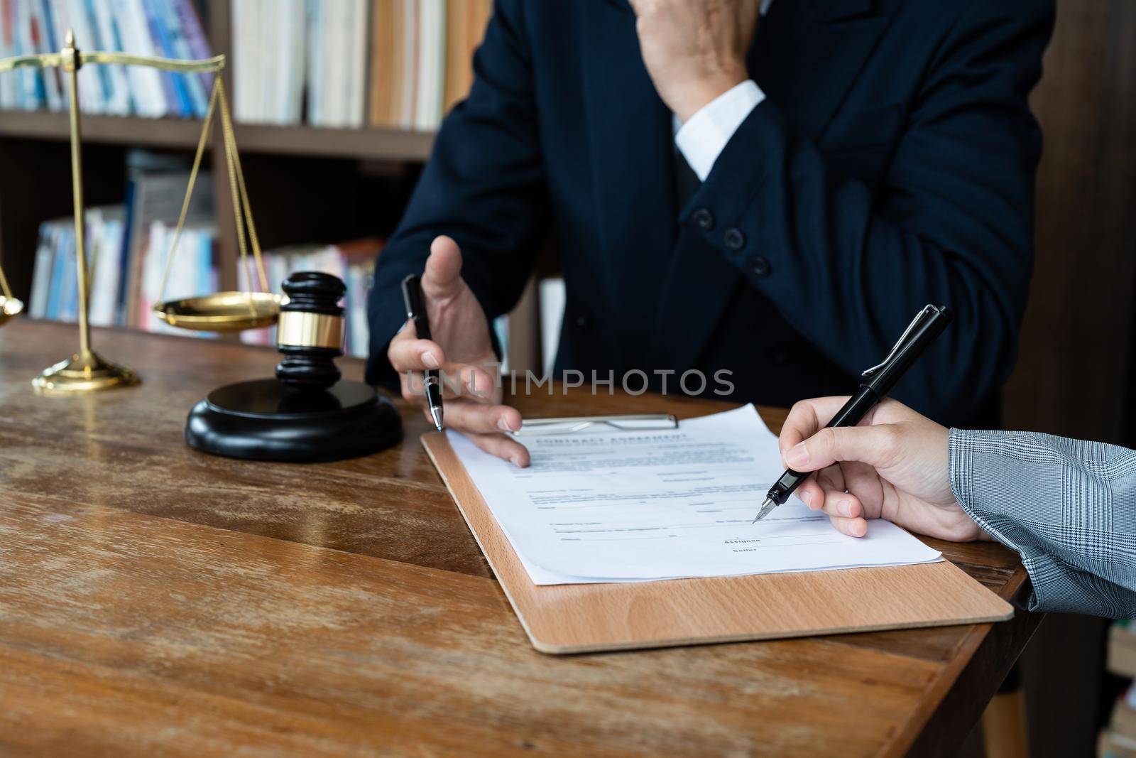 Business people negotiating a contract. Human hands working with documents at desk and signing contract.