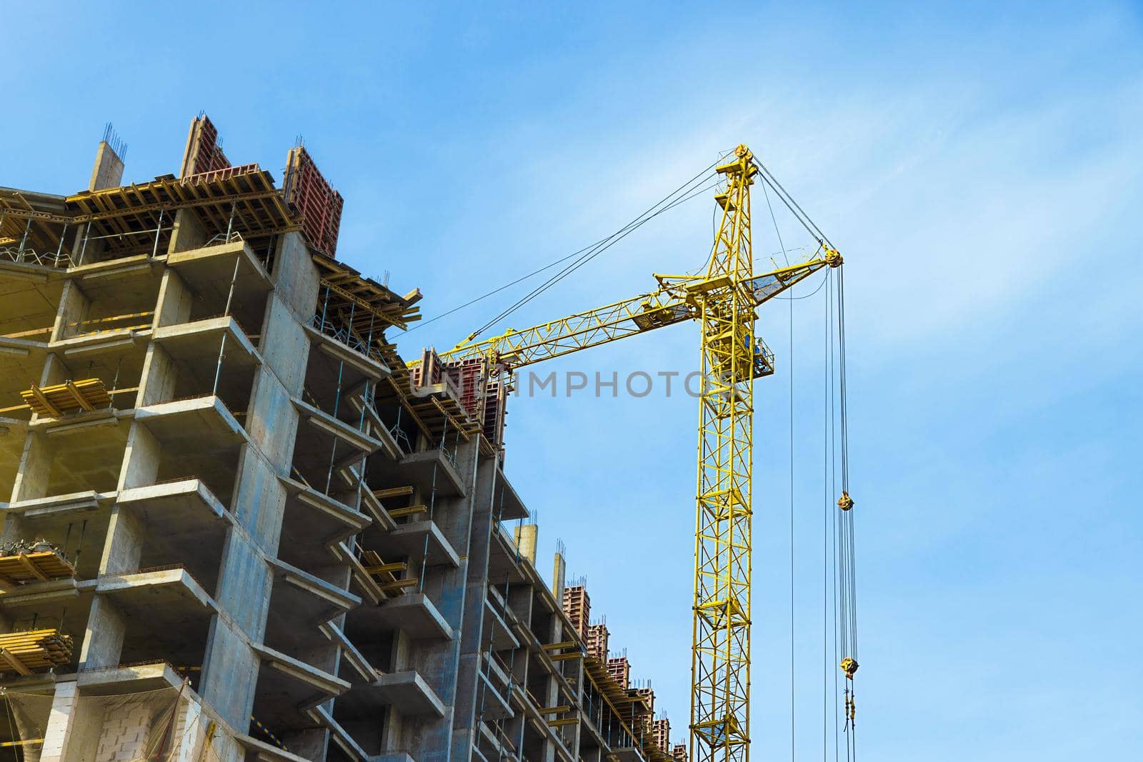hoisting crane against the blue sky. Construction site, construction site, large equipment. Urban environment, construction of skyscrapers, large residential complexes