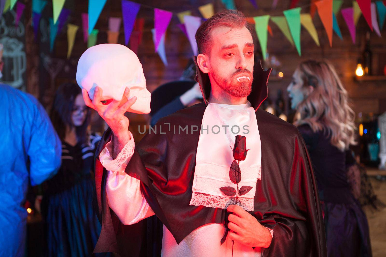 Handsome man dressed in a Dracula costume for halloween by DCStudio