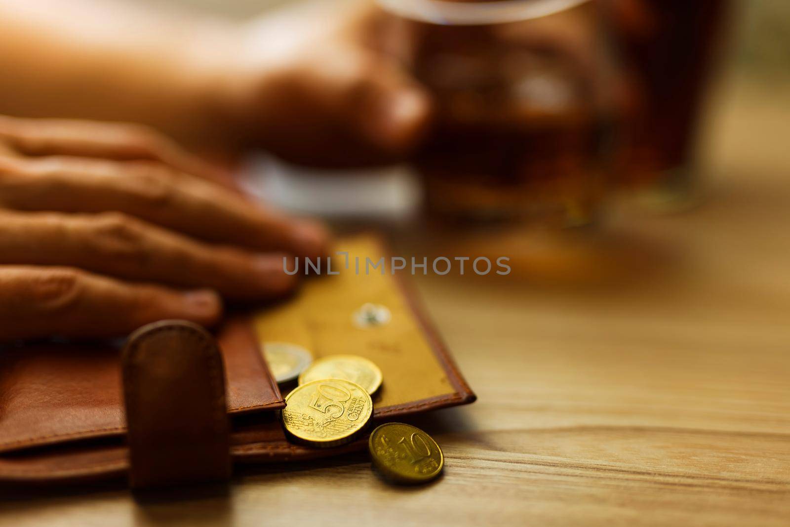 Fired man countsing his last money to drink expensive alcohol. by InnaVlasova