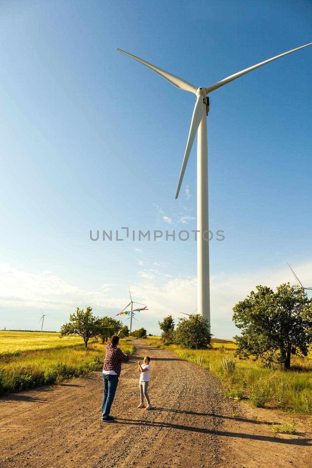 Happy father's day. Father and daughter having fun, playing with kite together on the Wheat Field on Bright Summer day