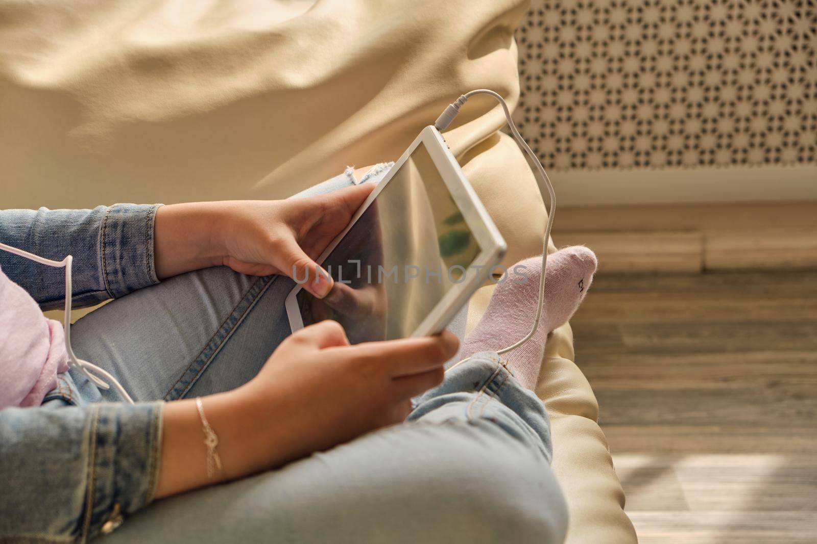 Cute little girl in casual clothes using a tablet by InnaVlasova