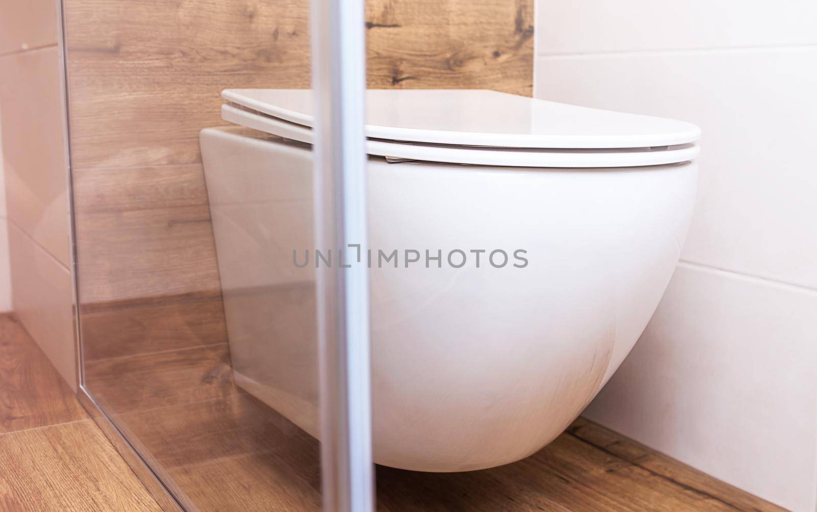 white toilet close-up in a modern bathroom. Sanitary equipment for a modern home by Ramanouskaya