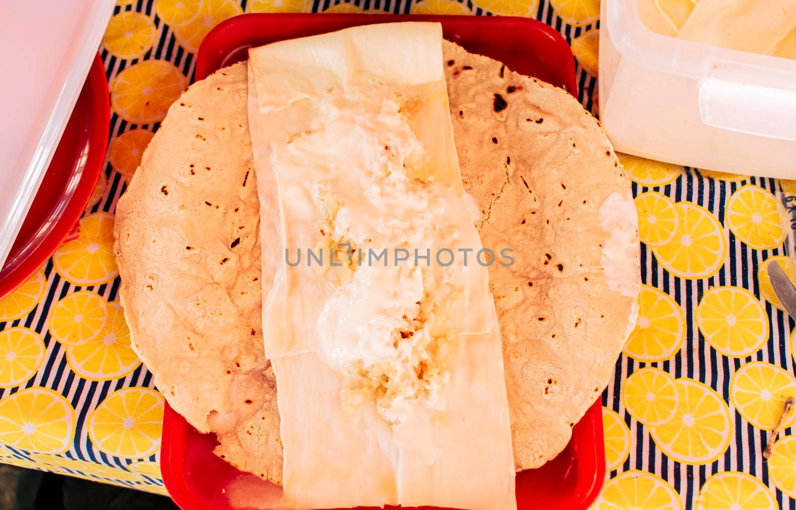 Top view of Nicaraguan Quesillo served on table. Traditional Nicaraguan Quesillo served on a plate on the table. Latin American food Quesillo, Traditional Quesillo with pickled onion