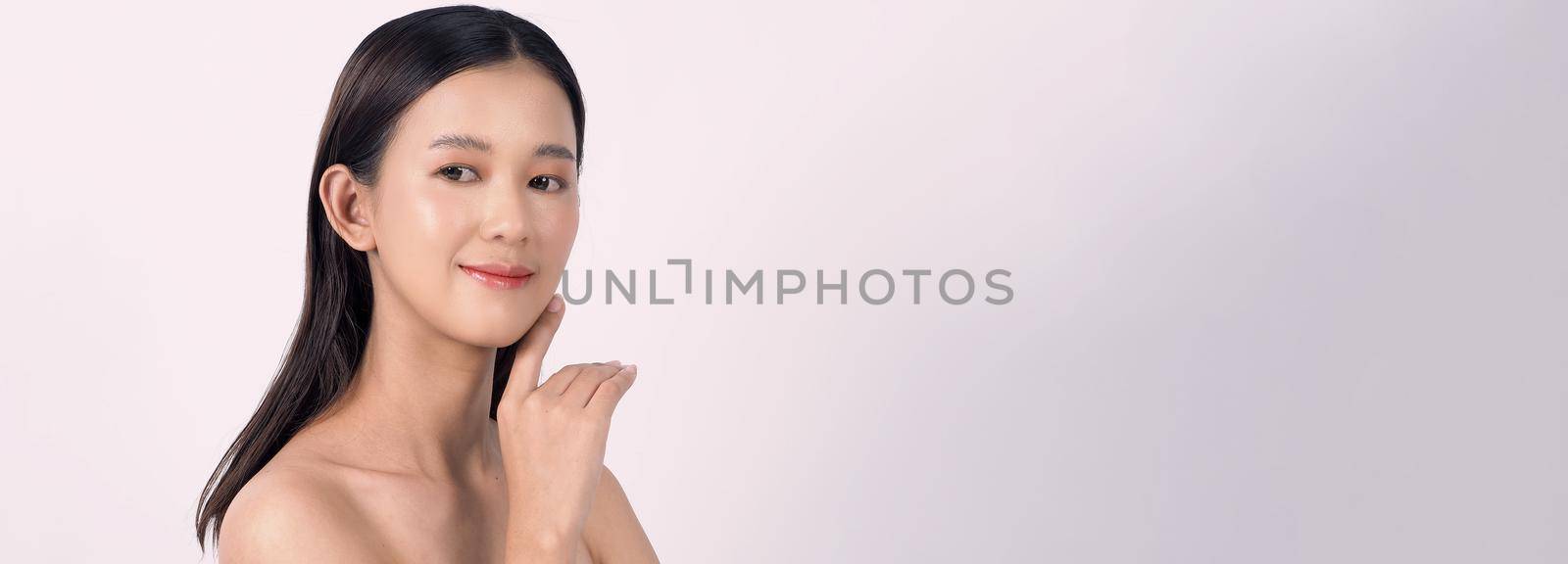 Beautiful young asian woman with clean fresh skin on white background. by gnepphoto