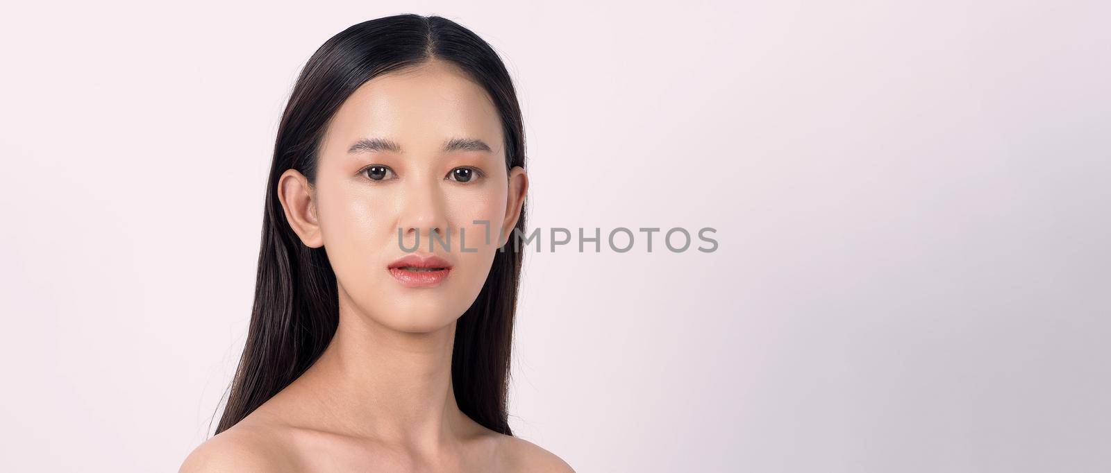 Beautiful young asian woman with clean fresh skin on white background. by gnepphoto