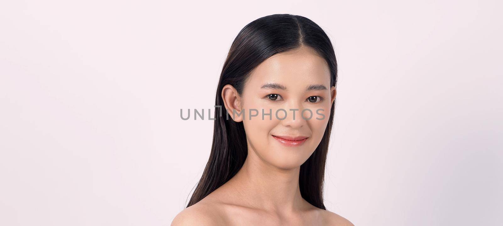 Beautiful young asian woman with clean fresh skin on white background. by gnepphoto