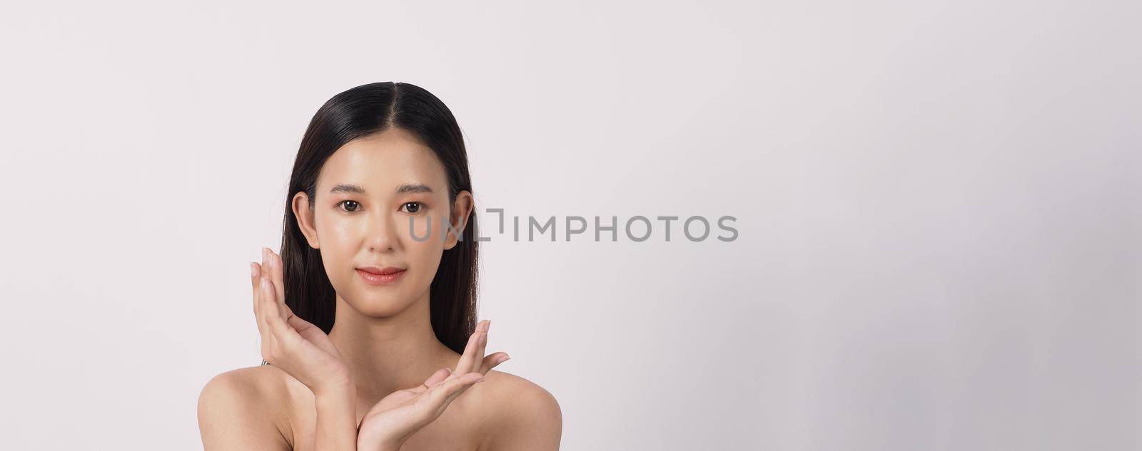 Beautiful young asian woman with clean fresh skin on white background. by gnepphoto