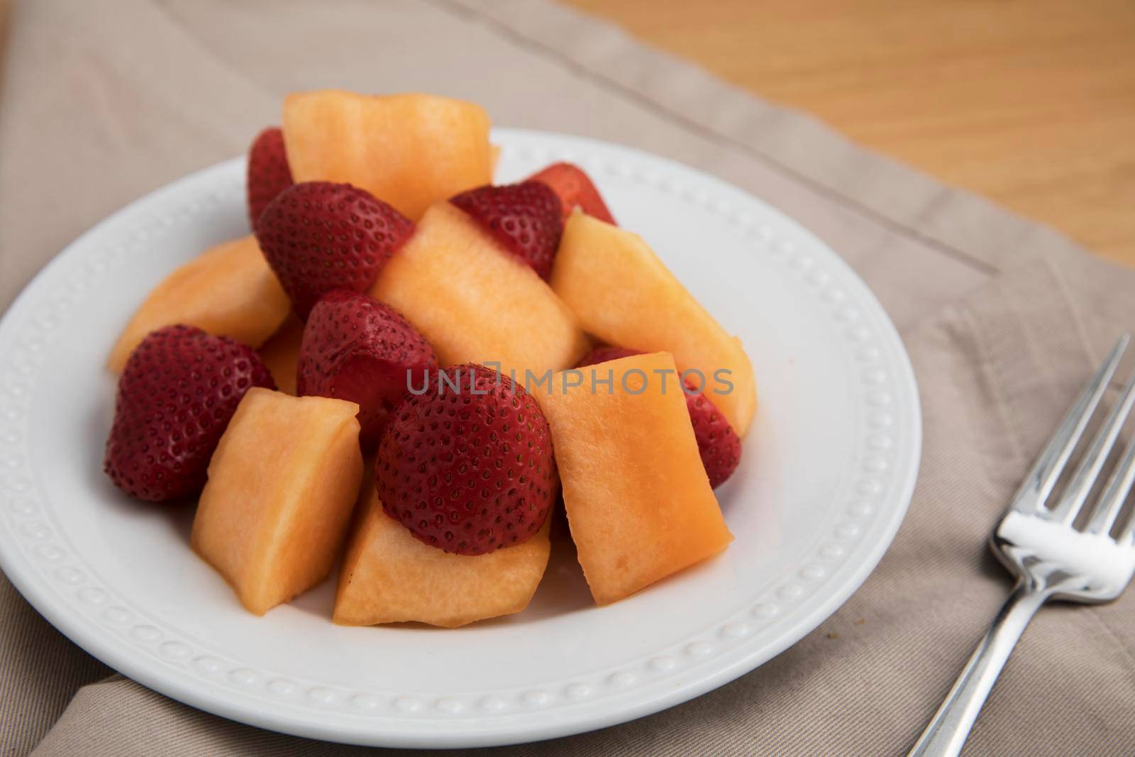 plate of fresh strawberries and cantaloup