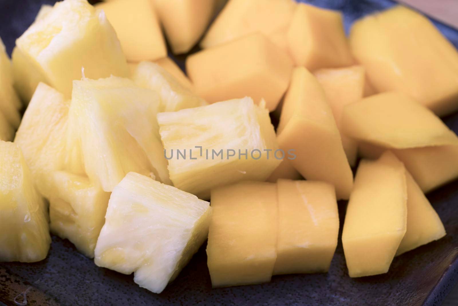 Chopped pineapple and mango close-up.