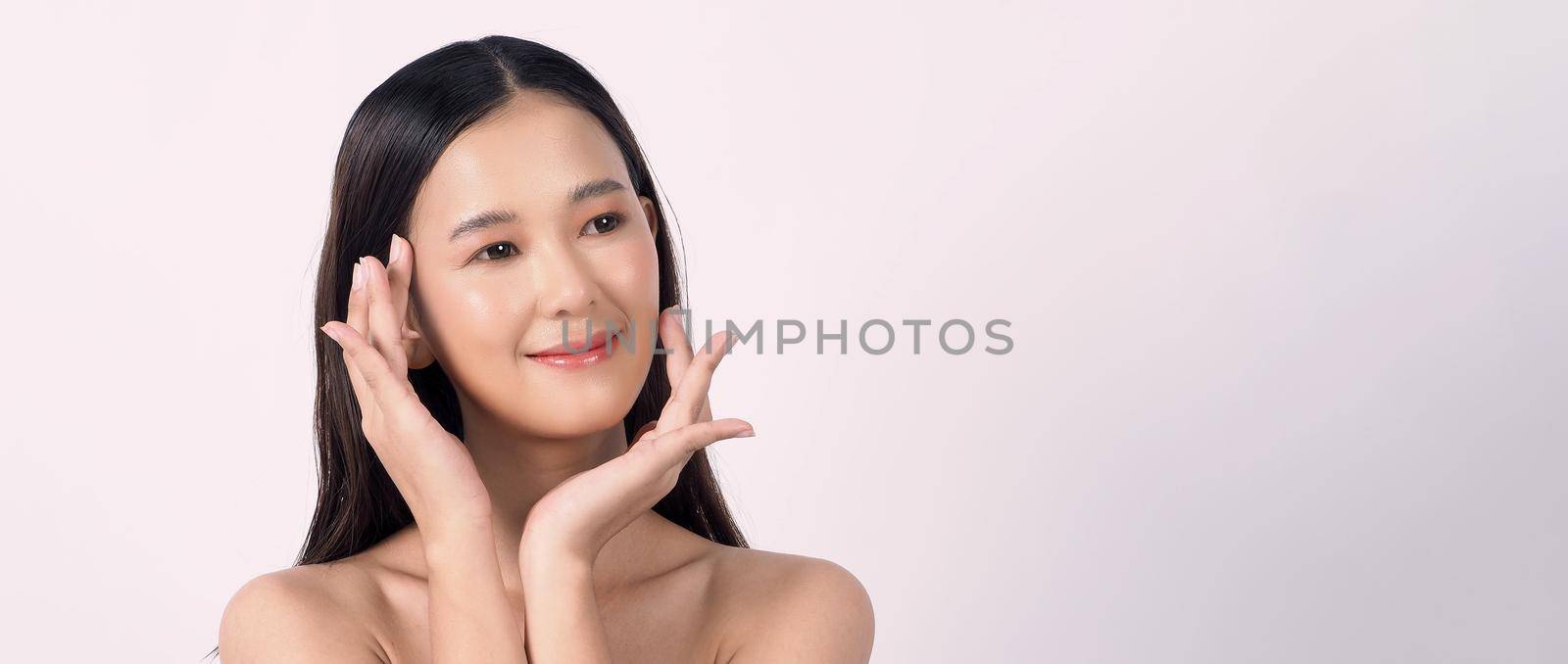 Beautiful young asian woman with clean fresh skin on white background. by gnepphoto