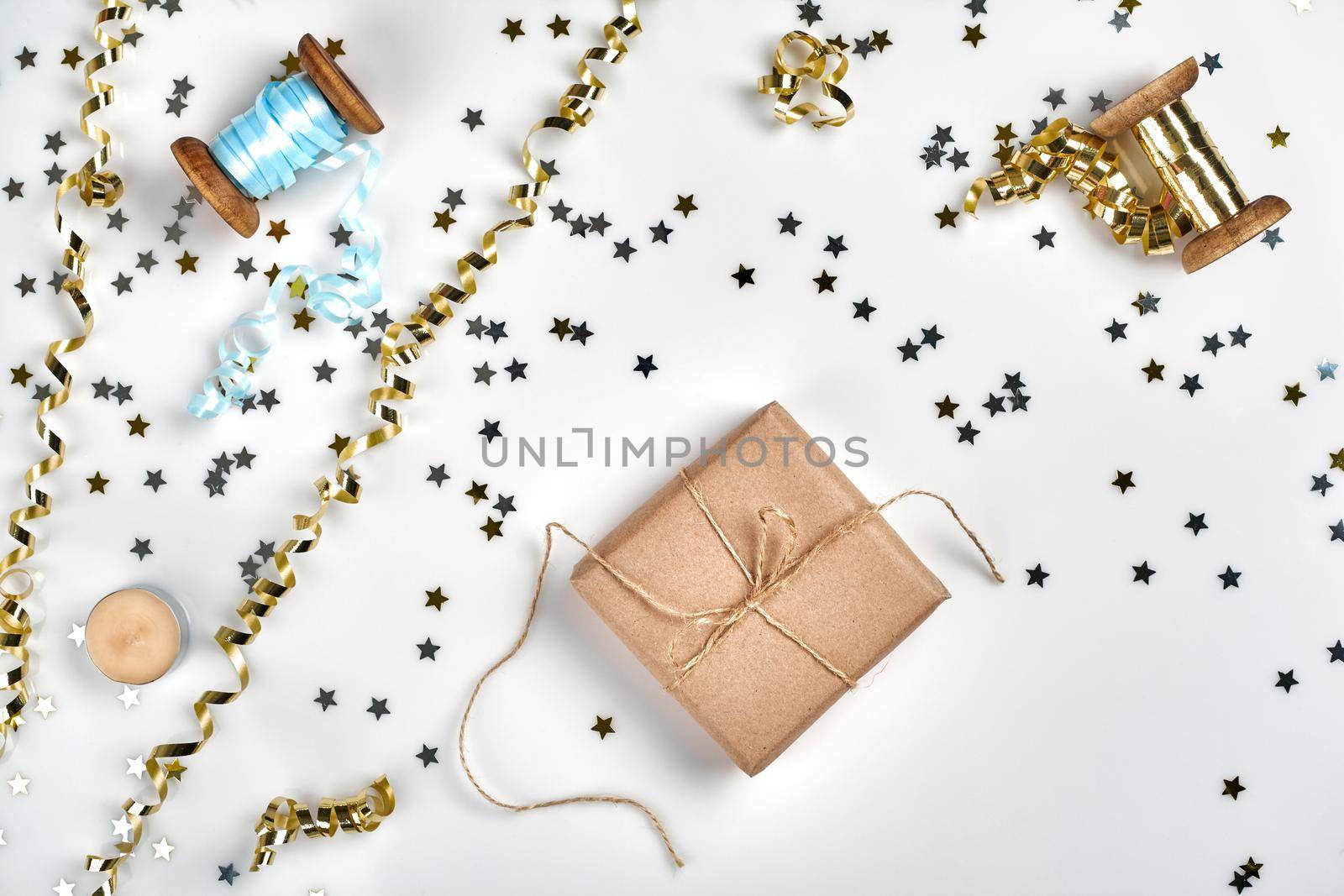 Delicate wavy ribbons and metallic star shaped confetti isolated on white background. Christmas holidays decoration concept. by nazarovsergey