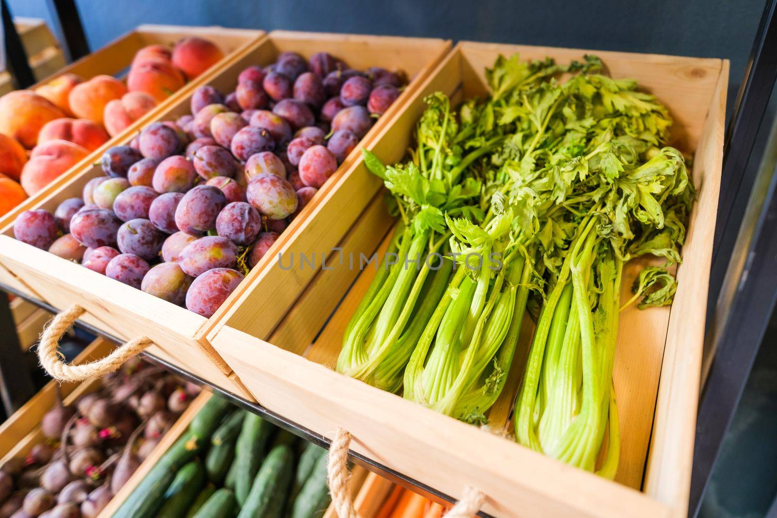 Healthy fruit and vegetables in grocery shop. Close up of baskets with various raw food in supermarket.