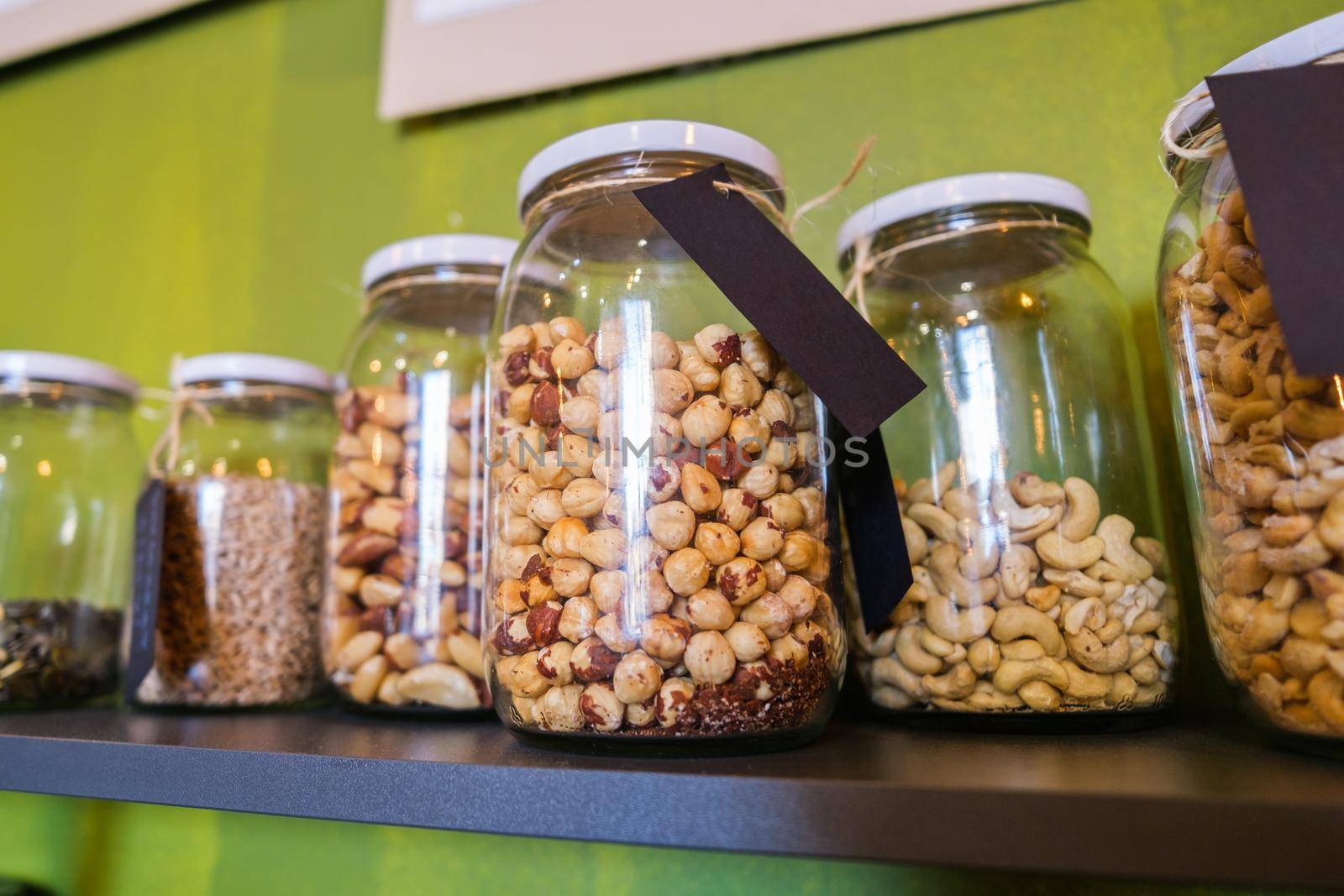 Close up image of jars with almond and other seeds in vegan food shop.