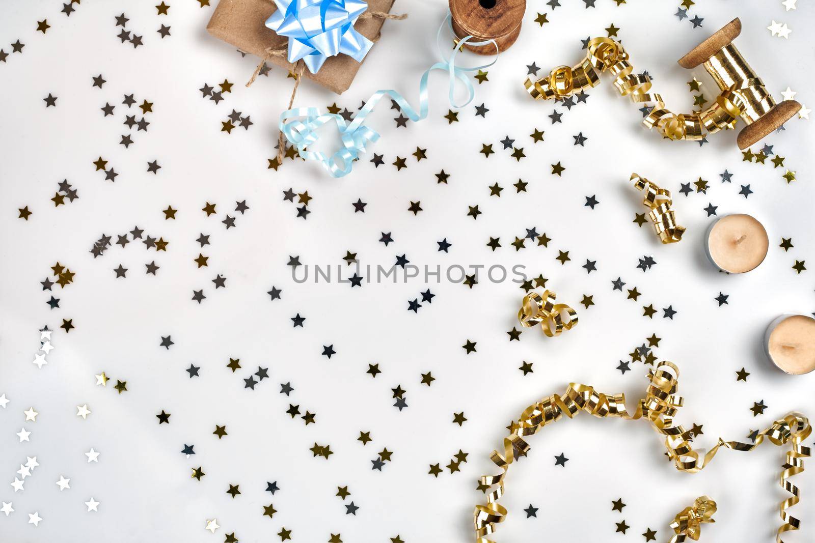 Delicate wavy ribbons and metallic star shaped confetti isolated on white background. Christmas holidays decoration concept. Perfect backdrop for your design.