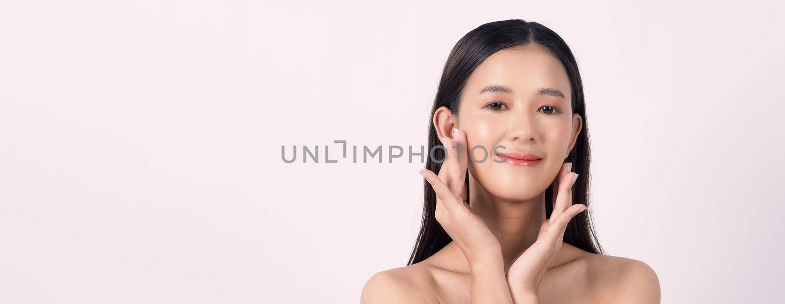 Beautiful young asian woman with clean fresh skin on white background. by gnepphoto