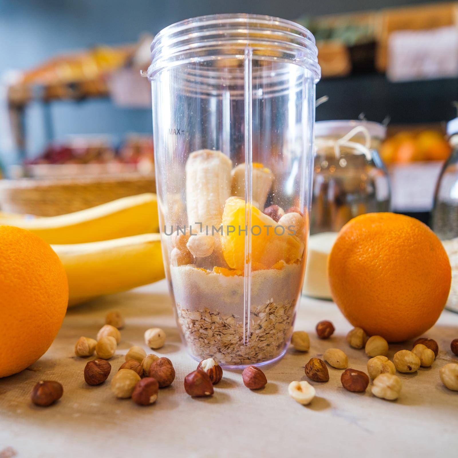 Healthy fruit shake on table with fruits and vegetables ingredients around.