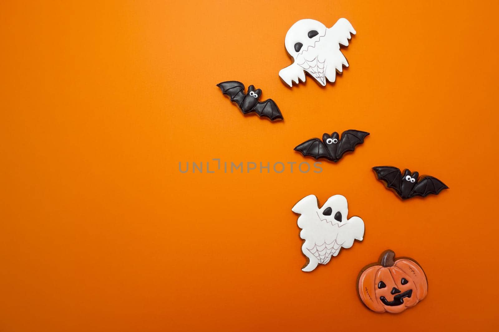 Gingerbread cookies for Halloween celebration are on an orange background. High quality photo