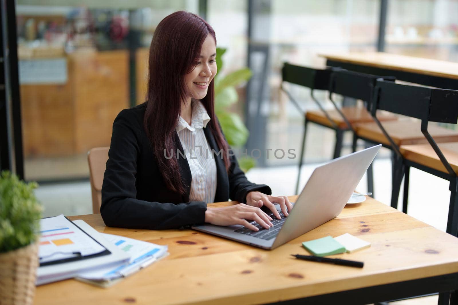 Portrait of a business woman using a computer to work on financial statements.