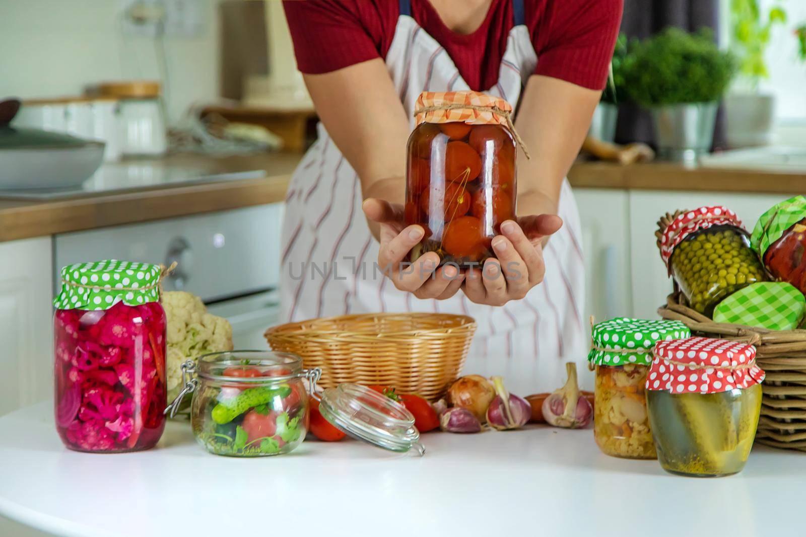 Woman jar preserve vegetables in the kitchen. Selective focus. Food.