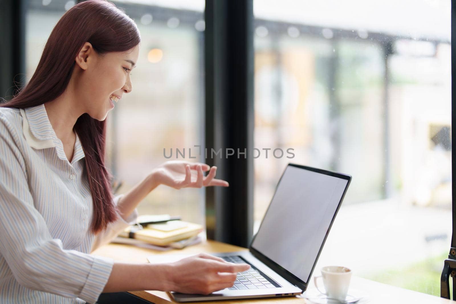 Portrait of a business woman using a computer to work on financial statements.