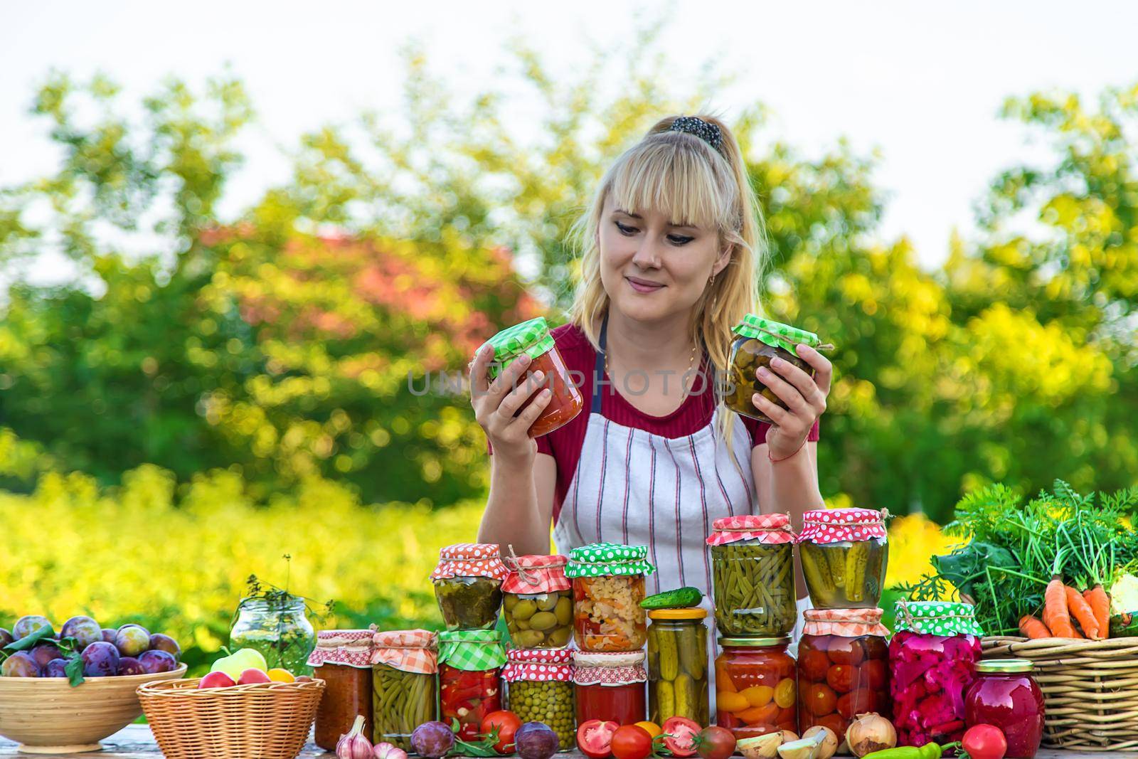 Woman with jar preserved vegetables for winter. Selective focus. Food.