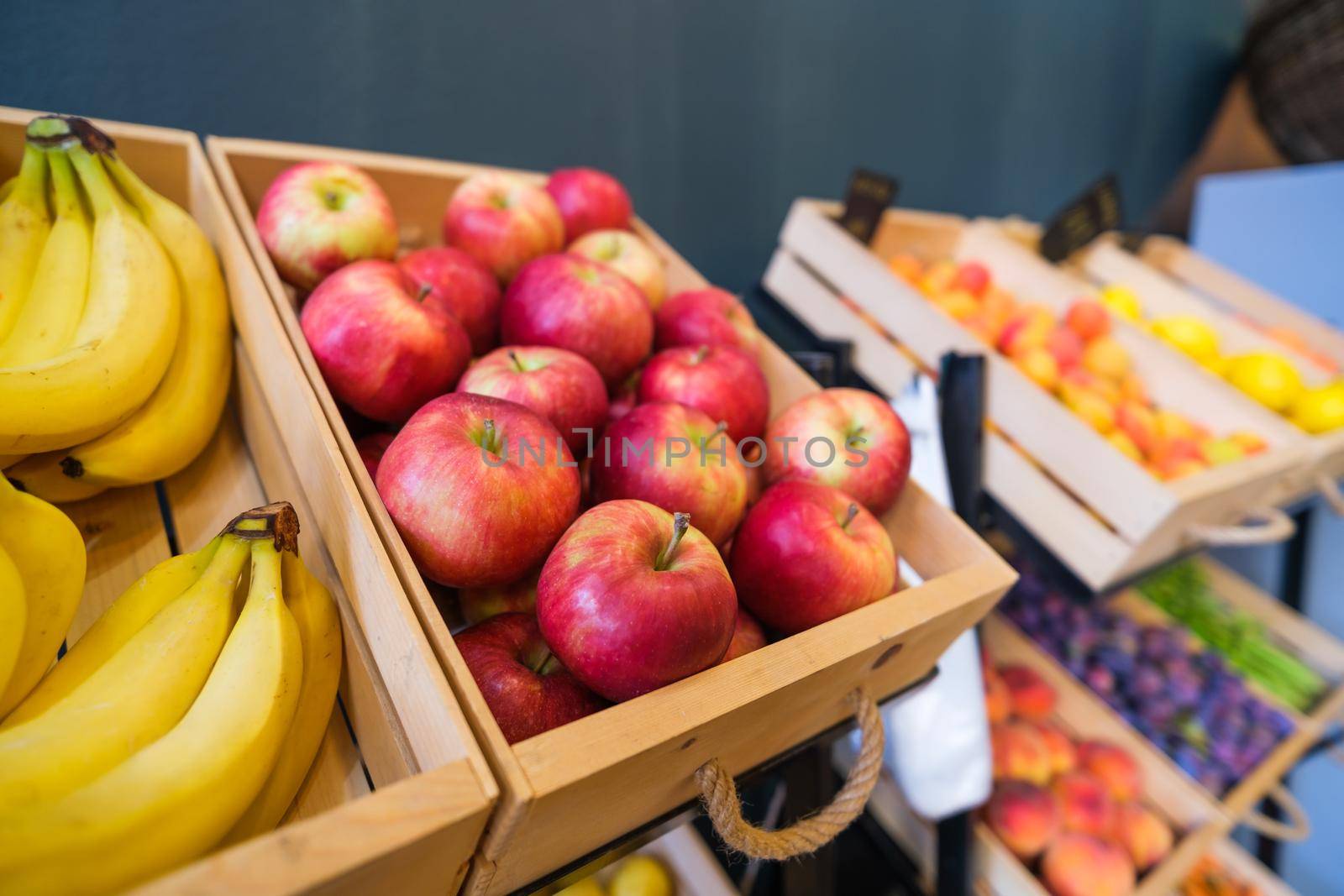 Healthy fruit and vegetables in grocery shop. Close up of basket with apples in supermarket.