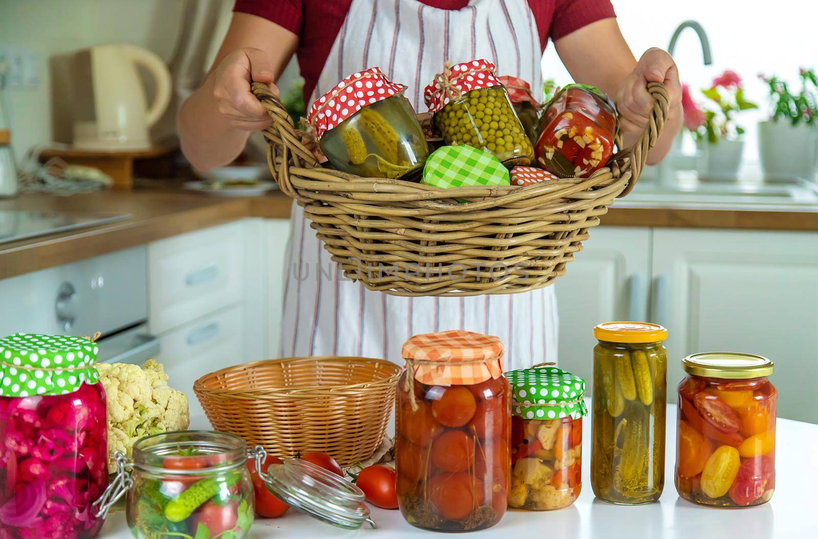 Woman jar preserve vegetables in the kitchen. Selective focus. Food.