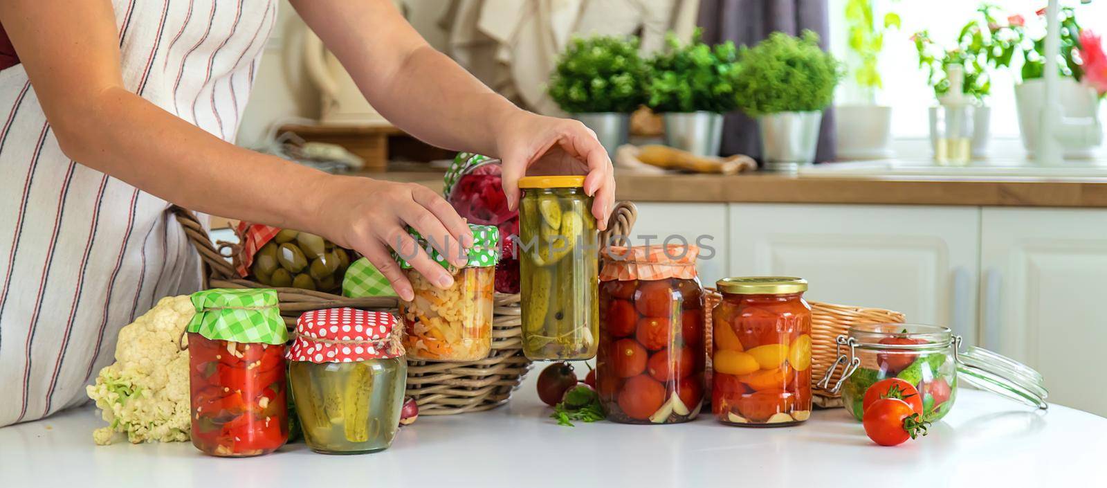 Woman jar preserve vegetables in the kitchen. Selective focus. Food.