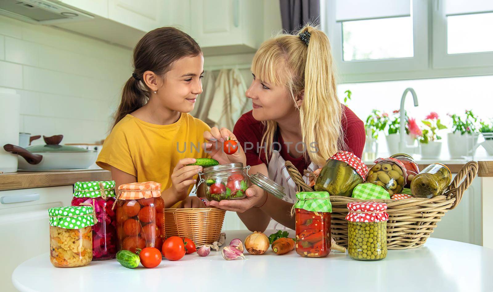 Woman with jar preserved vegetables for winter mother and daughter. Selective focus. Food.