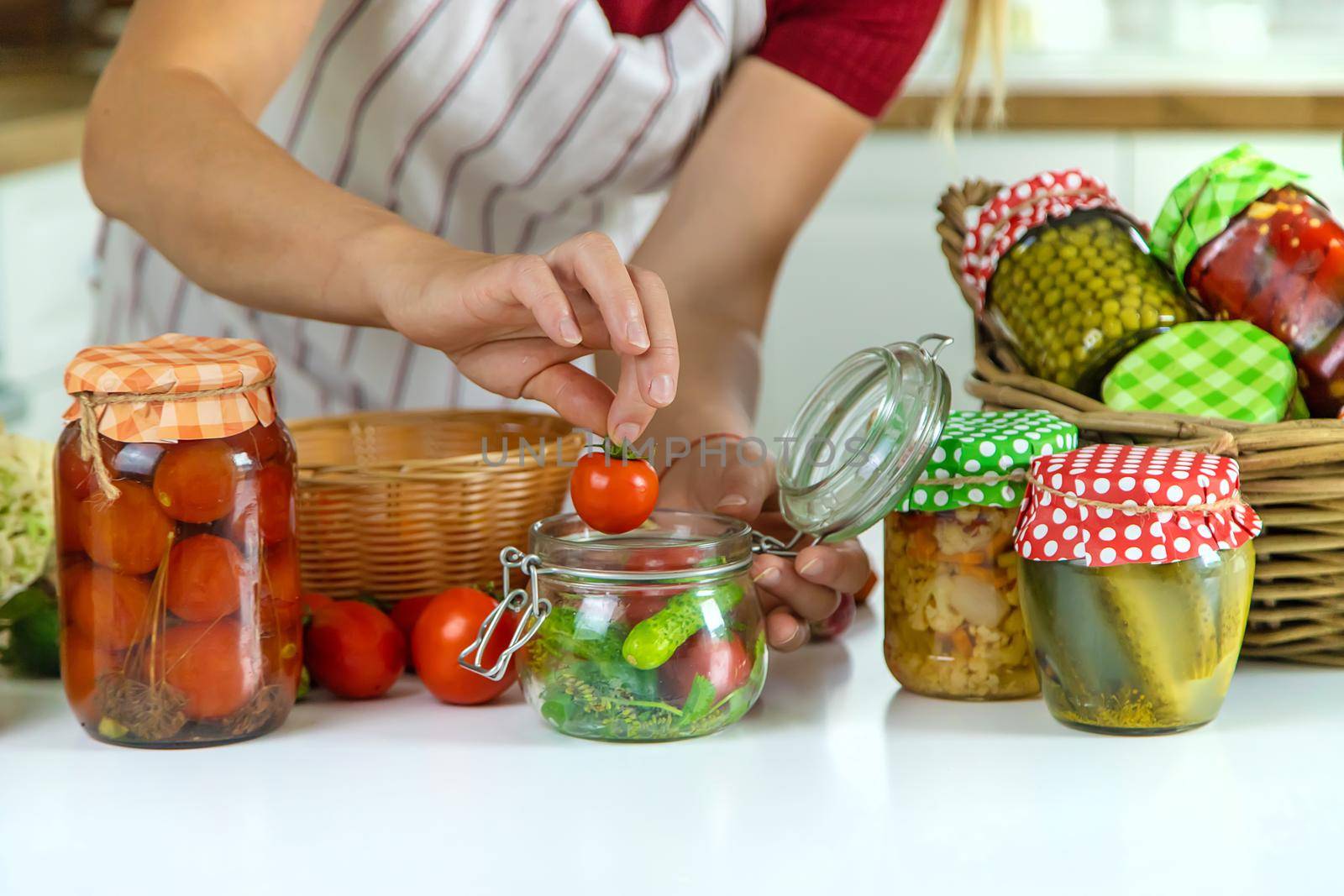 Woman jar preserve vegetables in the kitchen. Selective focus. Food.