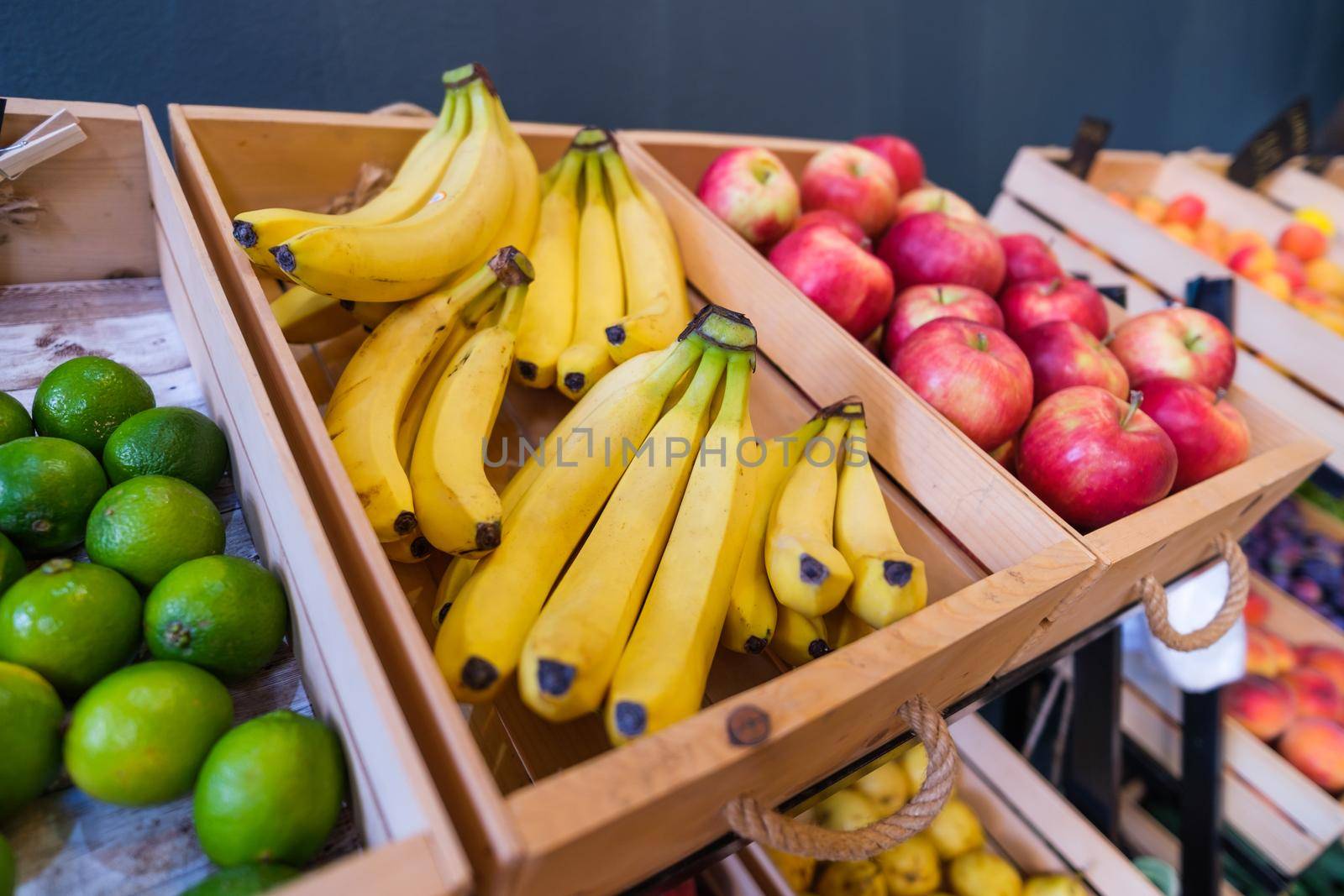 Healthy fruit and vegetables in grocery shop. Close up of basket with bananas in supermarket.