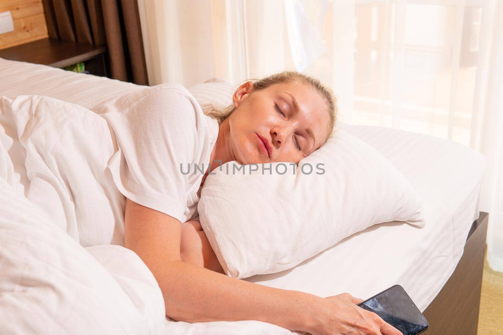 Woman phone beautiful sleep blonde mobile bed blanket eyes morning, for white relax in people and home rest, comfortable healthy. Relaxation cozy relaxing, lie by 89167702191