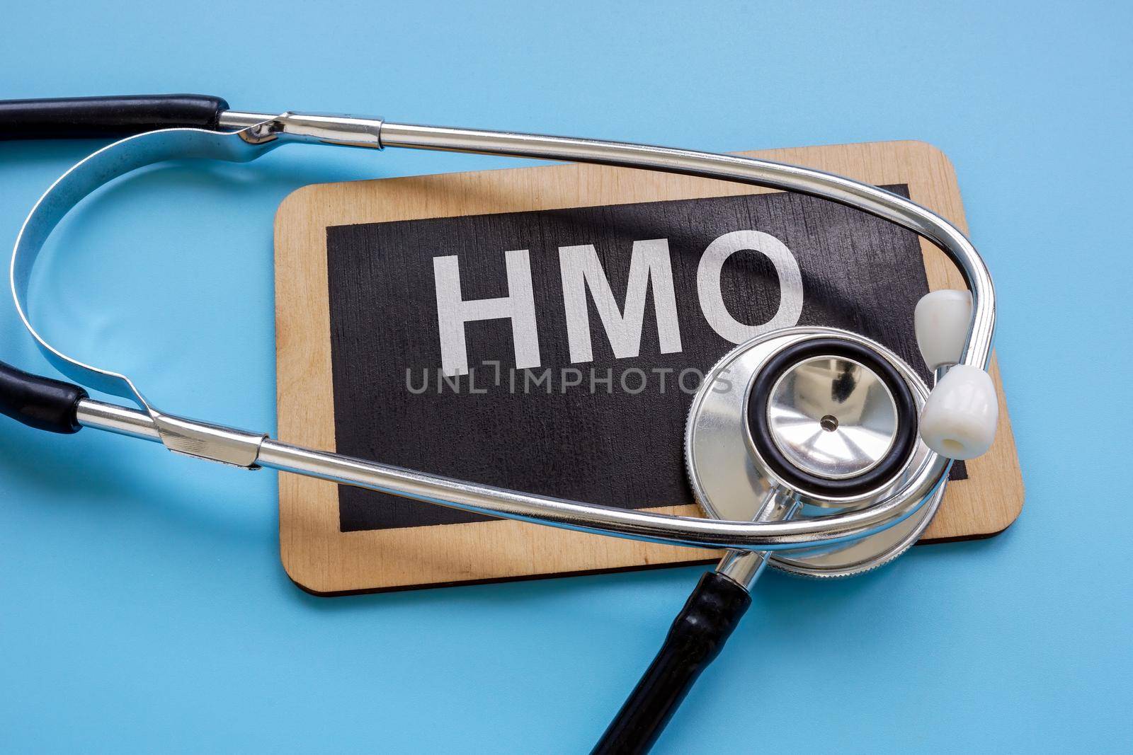 A Plate with an inscription Health Maintenance Organization HMO and a stethoscope.