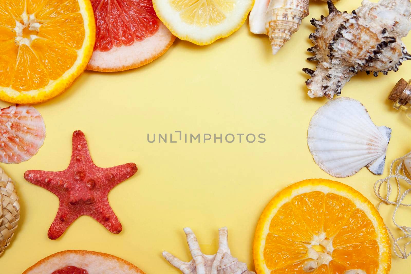 Summer frame of citrus fruits and shells with copy space. The concept of vacation, summer, vacation, travel by ssvimaliss