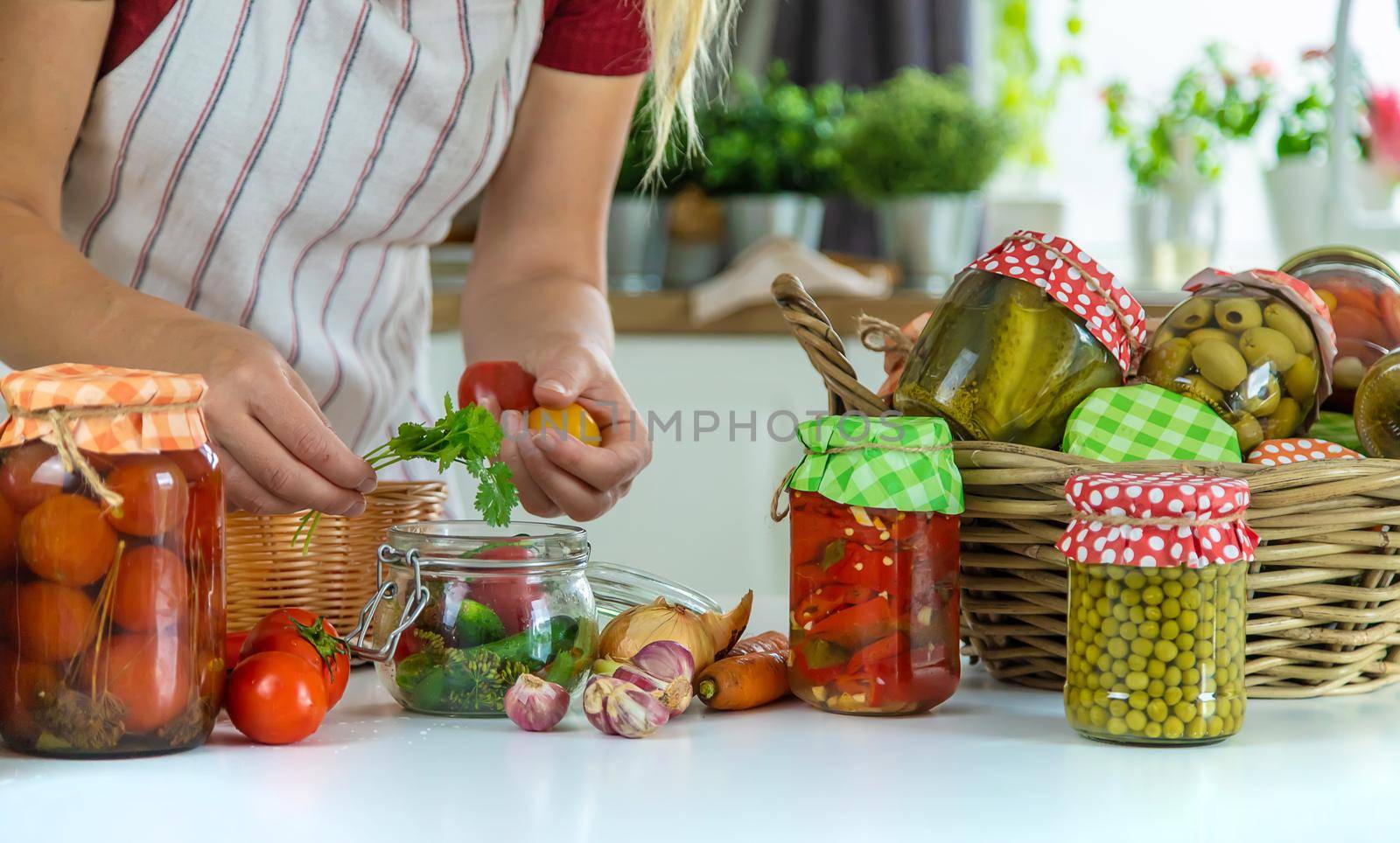 Woman jar preserve vegetables in the kitchen. Selective focus. Food.